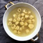 homemade tortellini in brodo (tortellini alla Bolognese) swimming in a glistening homemade stock