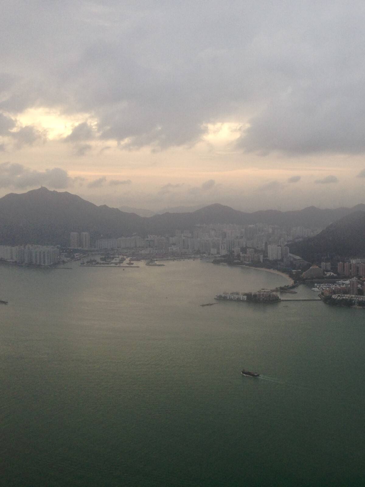 Hong Kong from the plane showing an inlet of beaches surrounded by water on one side and high rises on the other