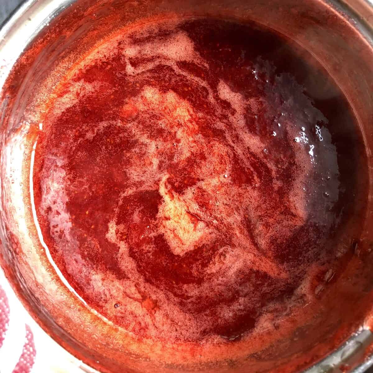 Just finished homemade strawberry jam in a pot.