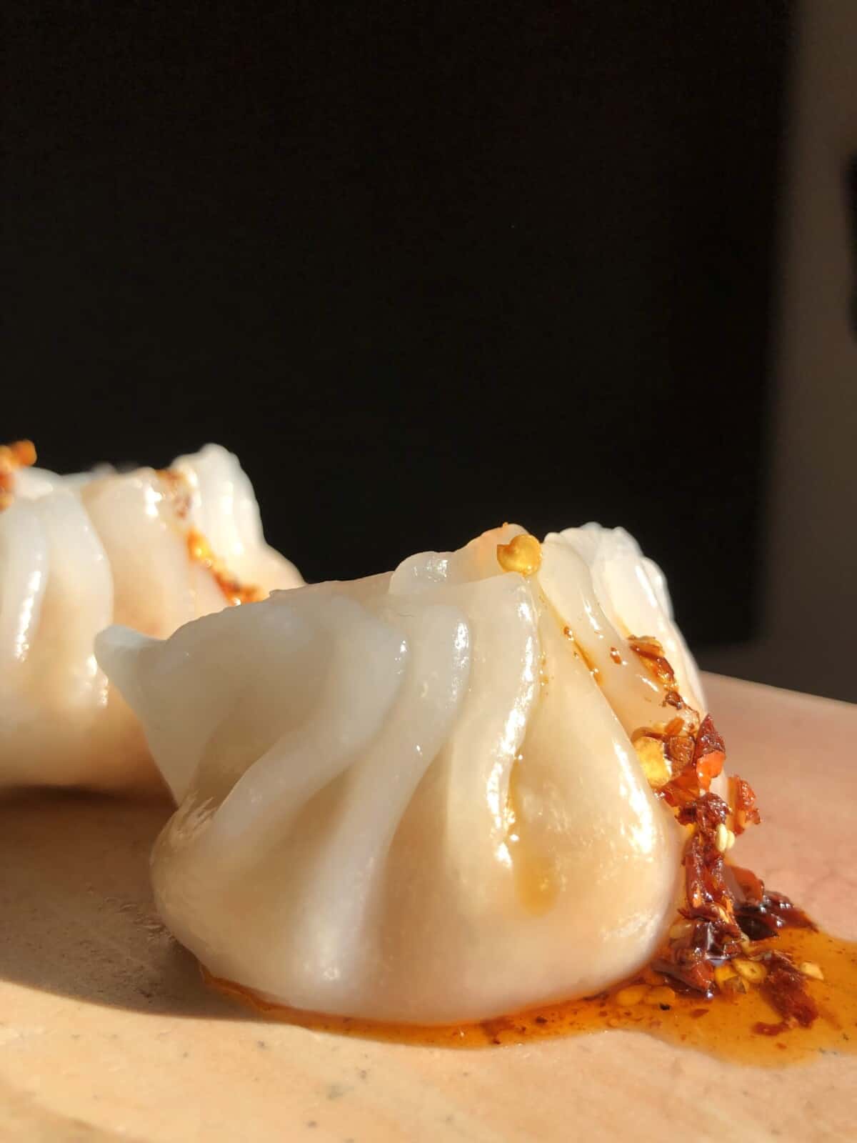 plump crystal shrimp dumplings drizzled with homemade sichuan crispy chili oil