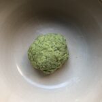 a very shaggy ball of green spinach pasta dough