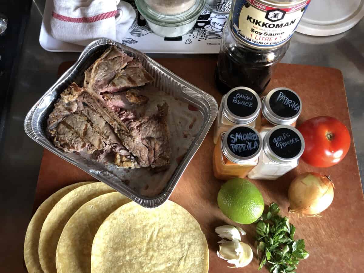 overcooked steak tacos ingredients on a cutting board