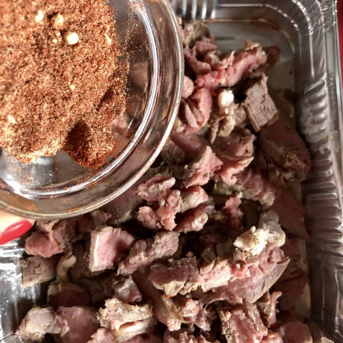 adding the spices to the beef