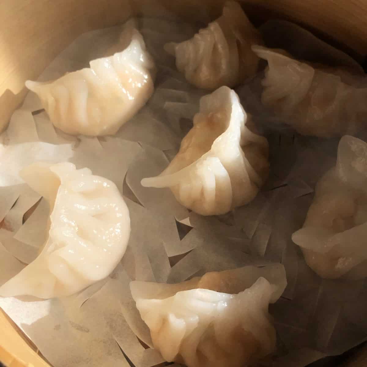 Hot steaming homemade har gow fresh out of the bamboo steamer ready to eat.

