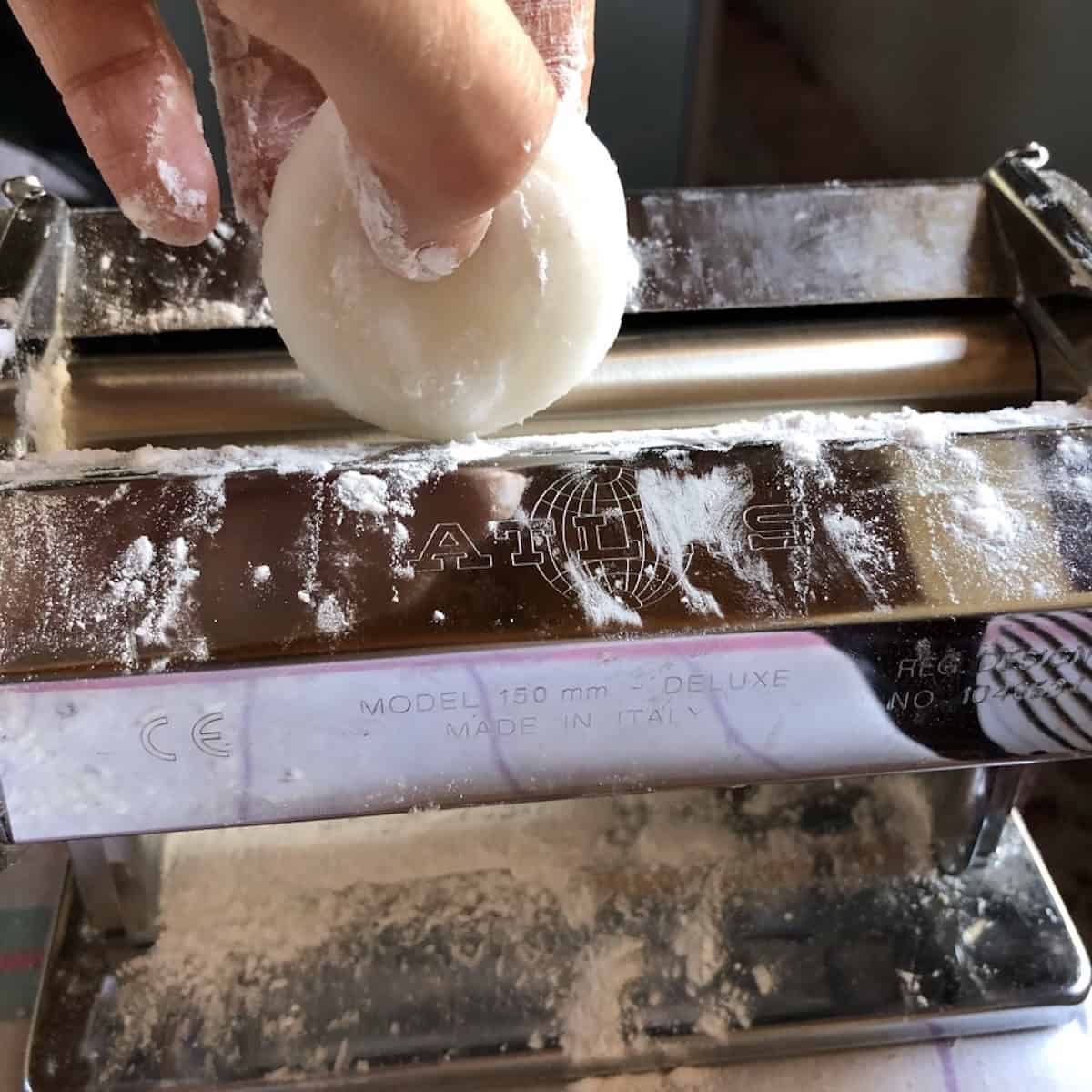 A portioned har gow wrapper dough ball about to be fed through a starch-dusted Atlas Marcato pasta machine with an electric drive attachment.
Flattened settings collage	har-gow-dumplings-wrapper-rolled-pasta-machine-settings	Har gow wrapper dough flattened after being fed through the pasta machine on settings two, three, and four showing the wrapper getting progressively thinner.
