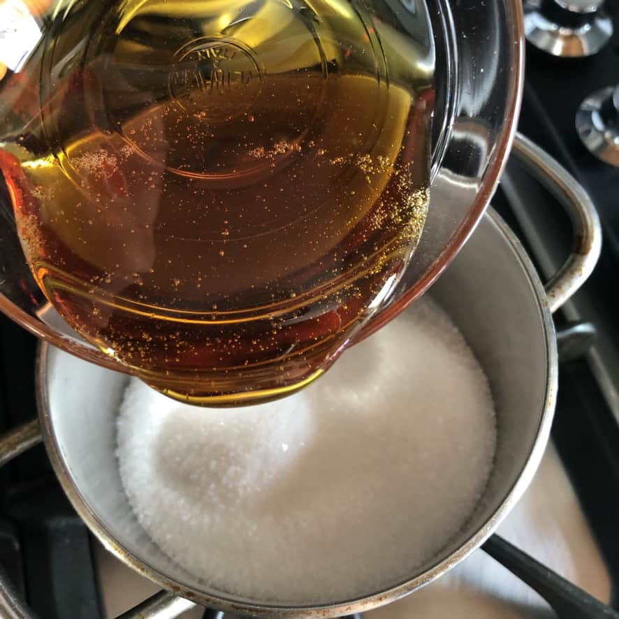 Adding golden syrup to the pot with sugar