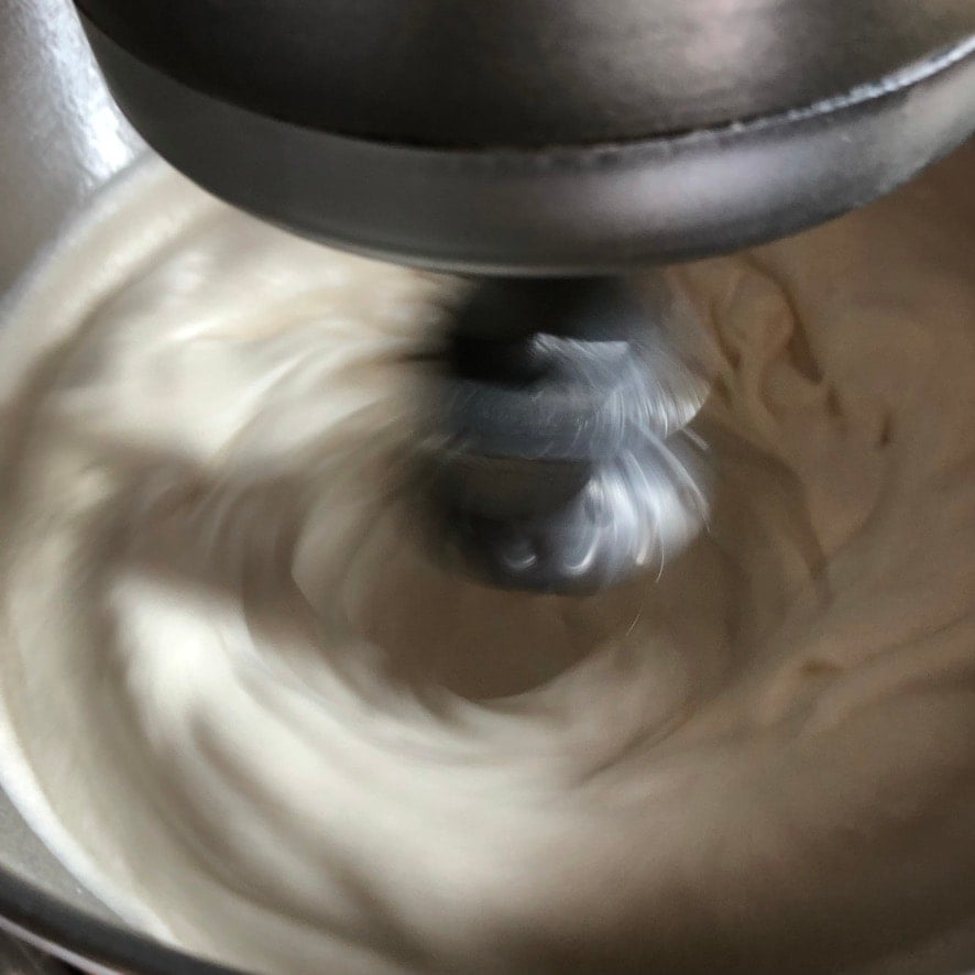 egg whites that are super fluffy and thick now and ready for the syrup the hot syrup mixture to be added