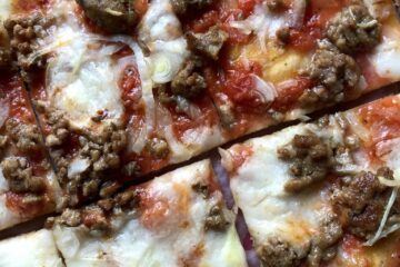 Thin and crispy sausage and onion St. Louis Style Pizza with a crispy cracker crust.