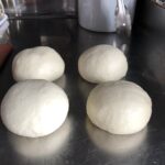 4 portioned dough balls ready to rise for 30 minutes.
