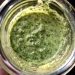 a jar full of bright green homemade kale pesto.