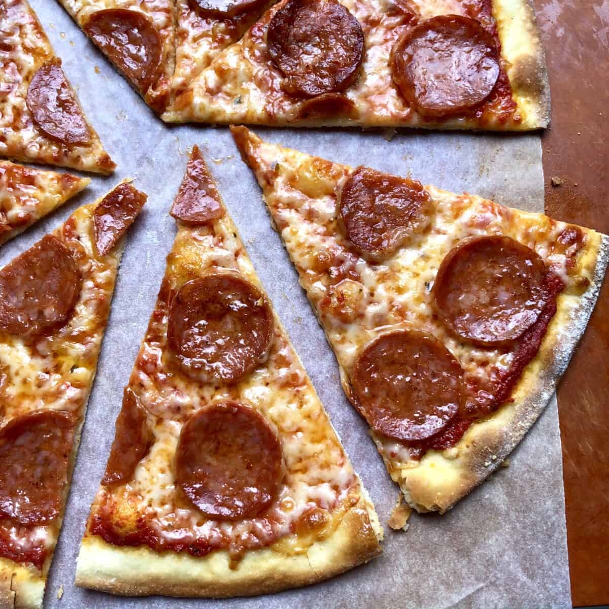 Sliced homemade 00 flour thin-crust pepperoni pizza