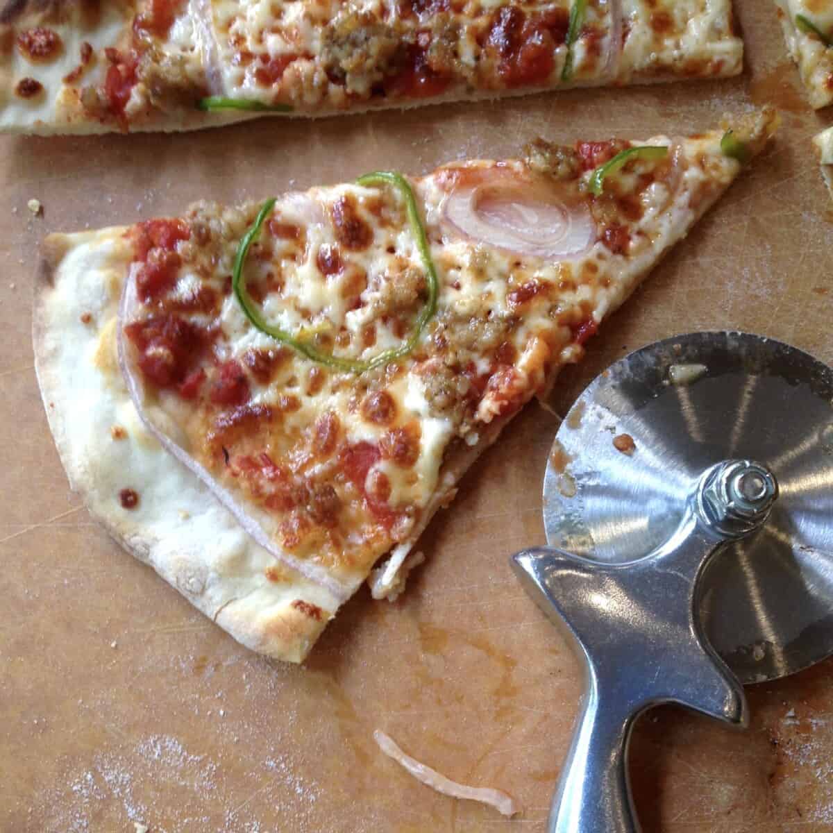 A thin crust pizza with a pale crust because no sugar was added to the pizza dough.