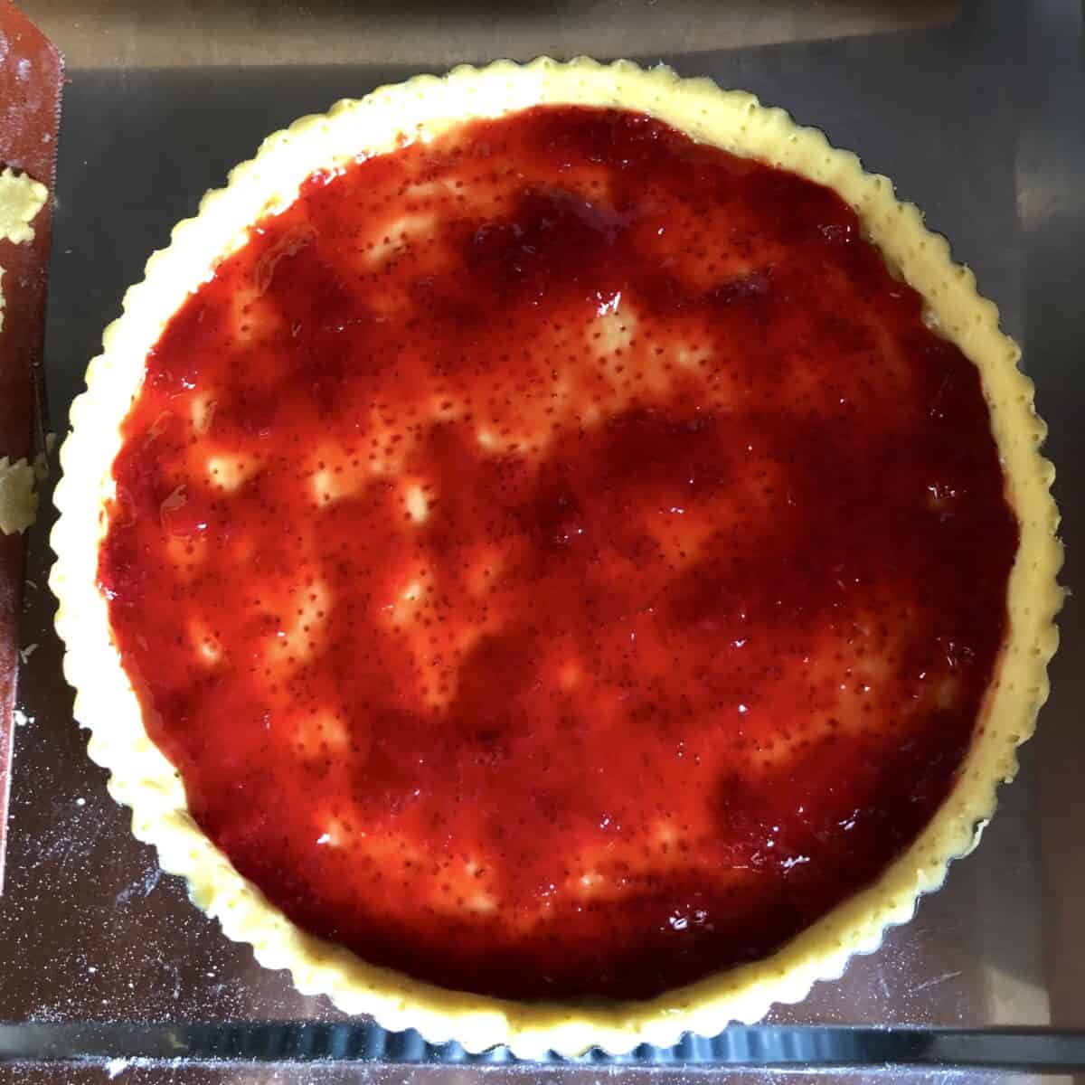homemade strawberry jam lining the bottom of the pastry crust