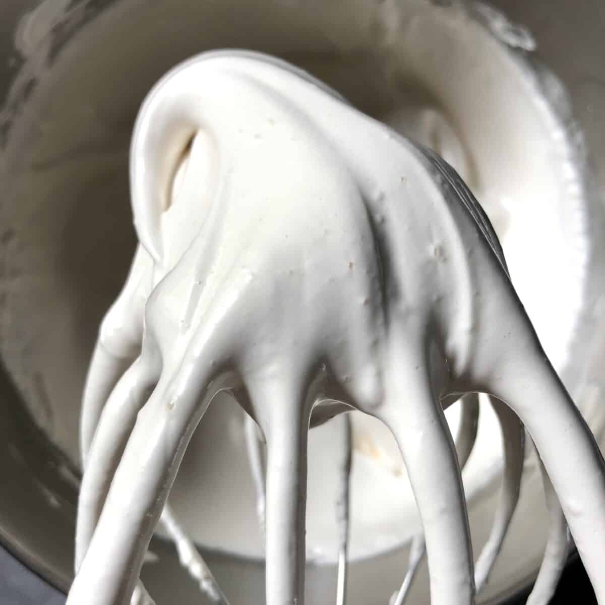 just whipped homemade marshmallow mixture holding its peak on a beater whisk