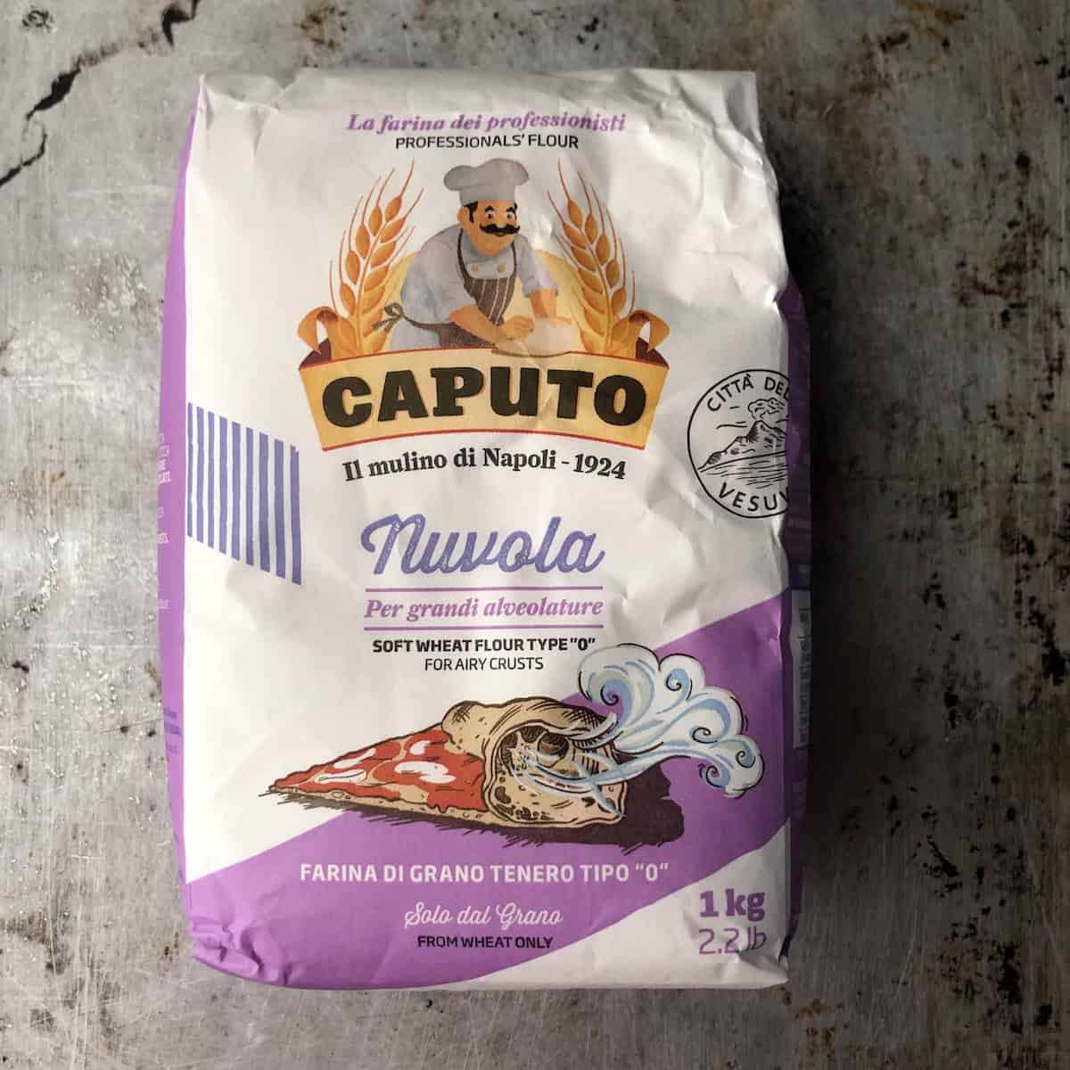 A white and purple bag of Caputo Nuvola flour for airy crusts (per grandi alveolature) type 0 flour with 12.5% protein soft wheat flour.