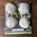 4 portioned dough balls ready fully risen in an oiled freezer bag.