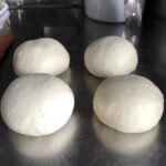 4 portioned bread flour dough balls ready to rise for 30 minutes.