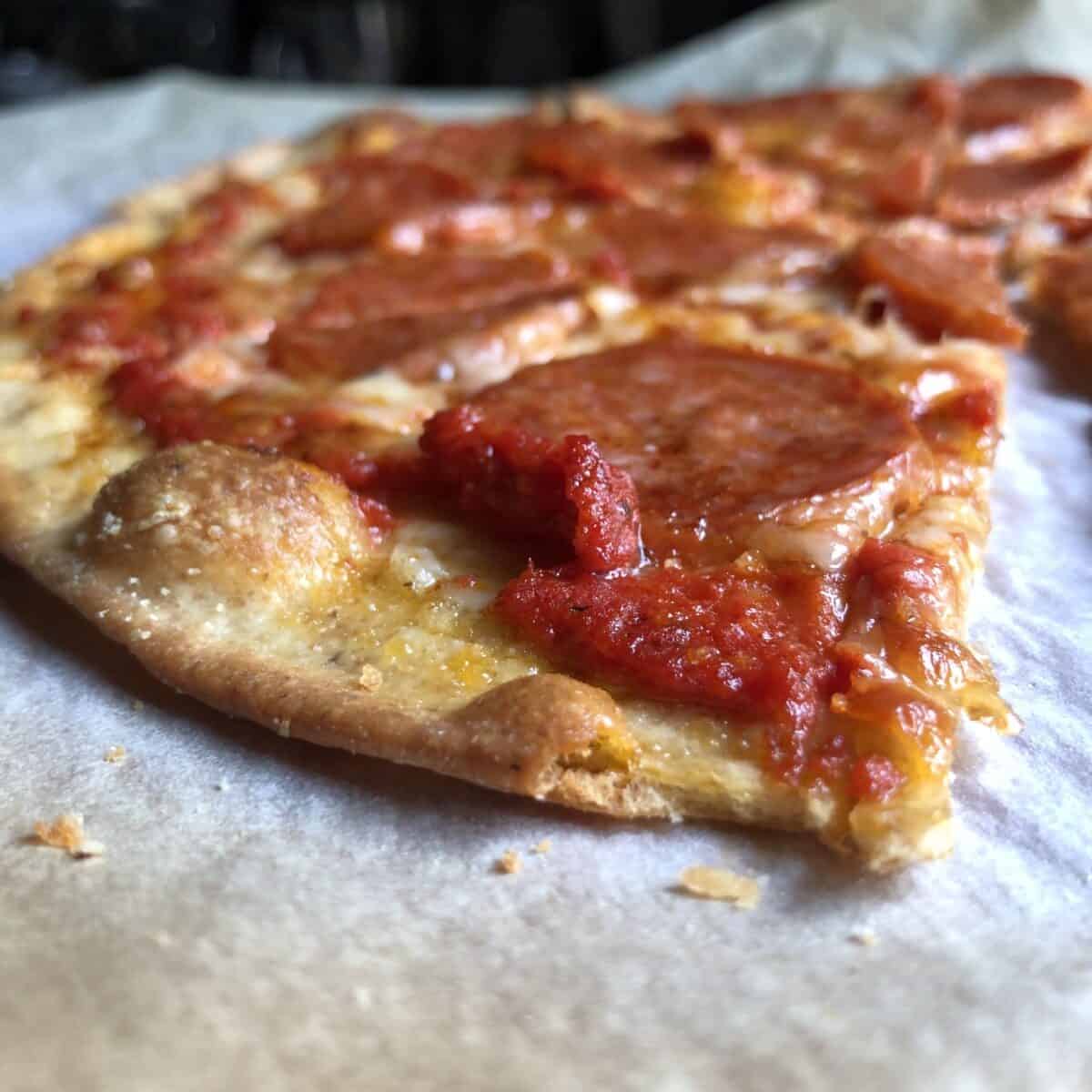 Slices of whole wheat thin crust pepperoni pizza on a plate