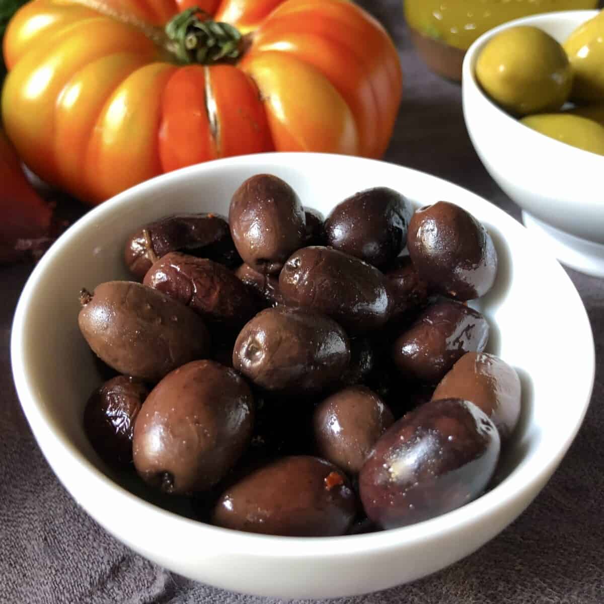 Cured black Kalamata olives in a bowl.