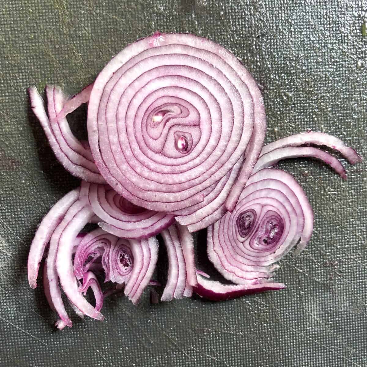Paper thin sliced red onions.