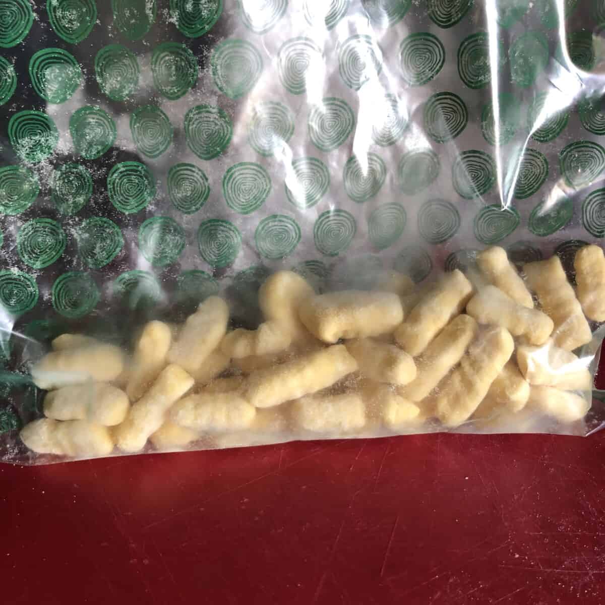 frozen gnocchi added to a freezer bag for longterm storage.