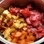 diced fresh and frozen strawberries, fresh nectarines, and fresh apricots in a medium pot.