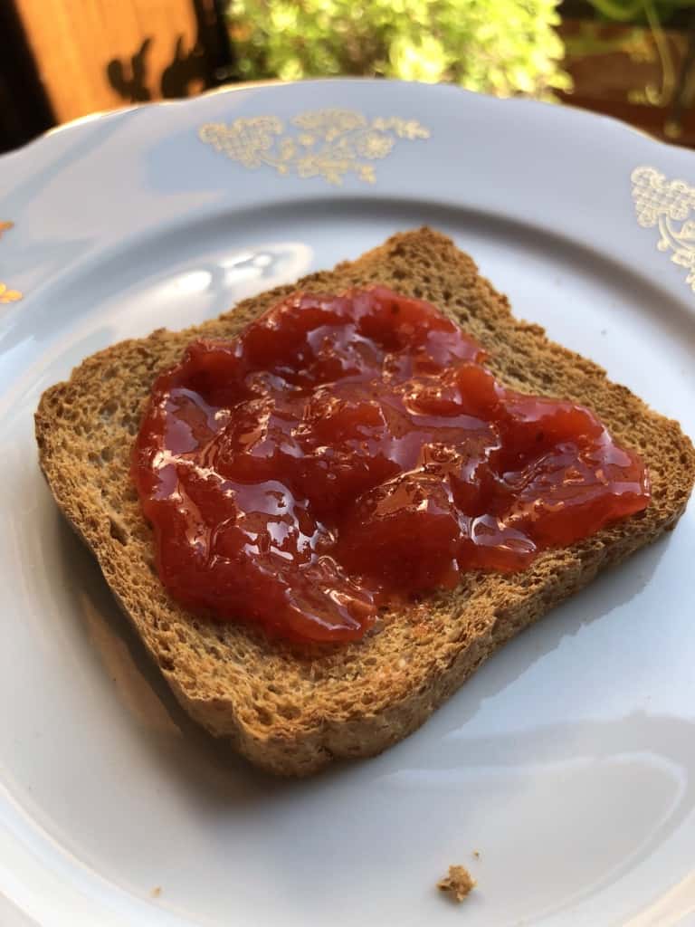 A small fette biscottata which is an Italian toast smeared with homemade strawberry-apricot-nectarine jam.