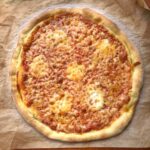 00 flour thick crust baked pizza that is golden brown with a thick outer crust and thin bottom.