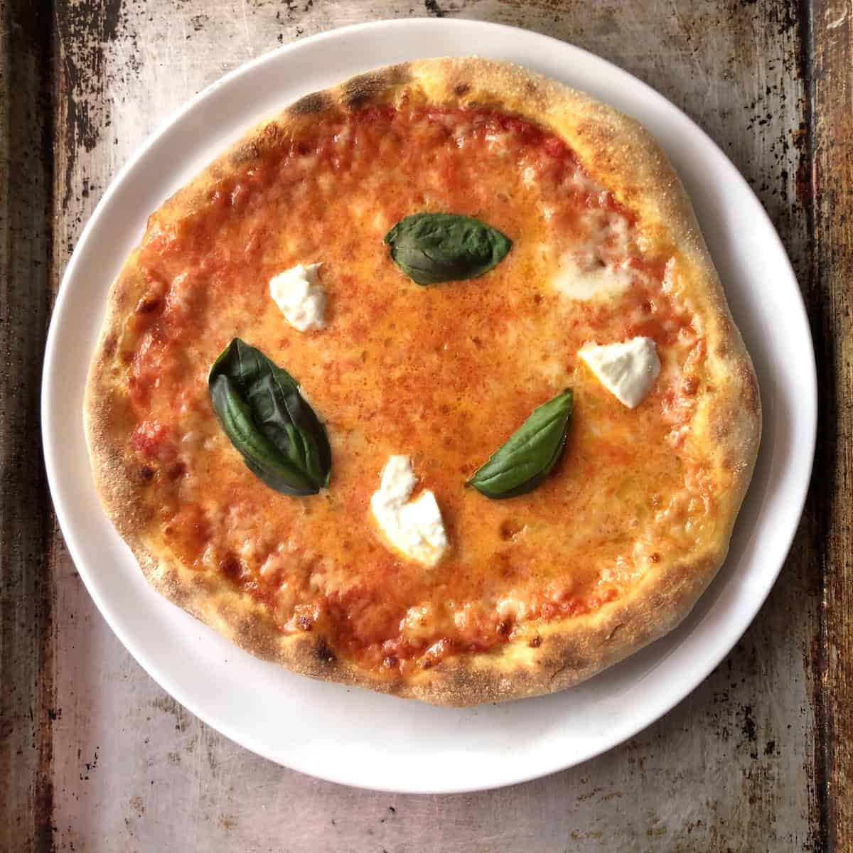 How to cook thick crust pizza margherita with buffalo mozzarella added after baking Italian style, whole milk mozzarella, and fresh basil for a thick and thin pizza crust comparison.