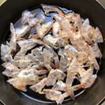 shrimp shells being cooked in evoo to build the sauce for paccheri di gragnano pasta