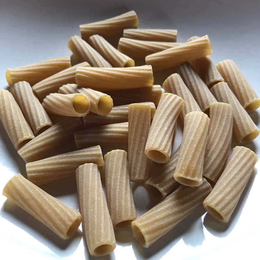 Whole wheat (integrale) Tube-shaped Italian maccheroni (macaroni) pasta in a bowl before being cooked.
