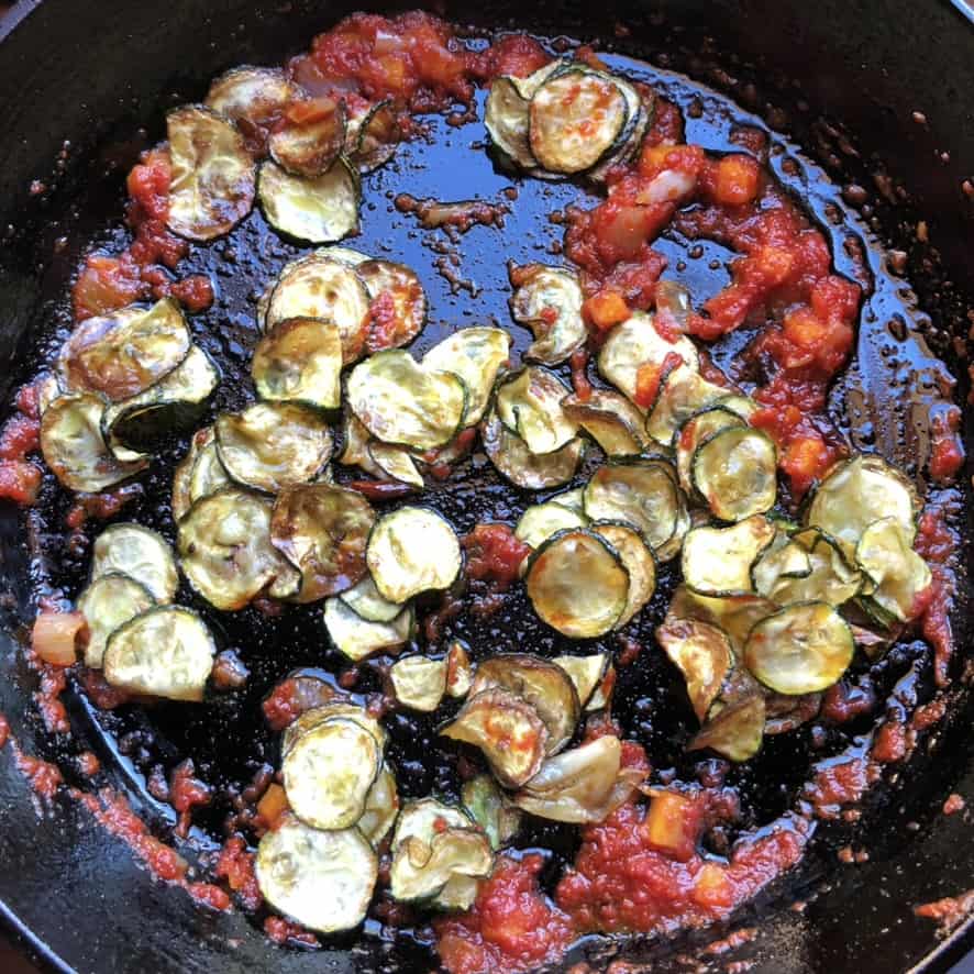 zucchini and tomatoes in the skillet to make the base of the paccheri with shrimp pasta