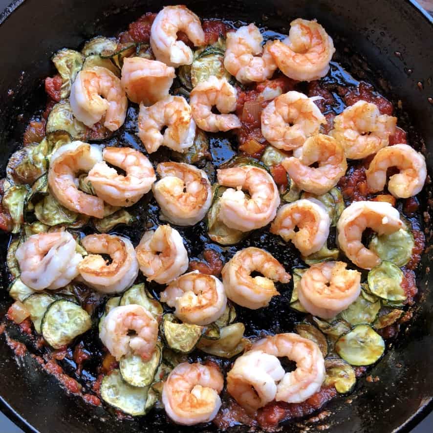 shrimp pasta sauce with zucchini in a skillet without pasta water added yet.