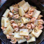 paccheri added to the shrimp sauce and tossed together .