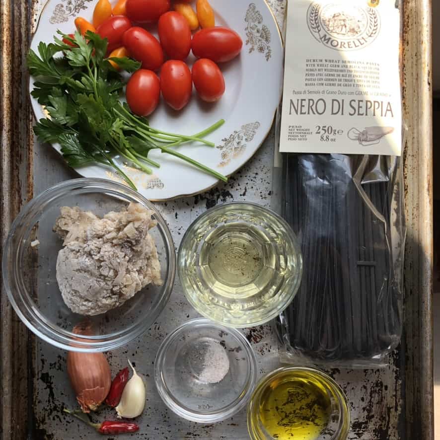 Black linguine and crab pasta ingredients on a half sheet pan