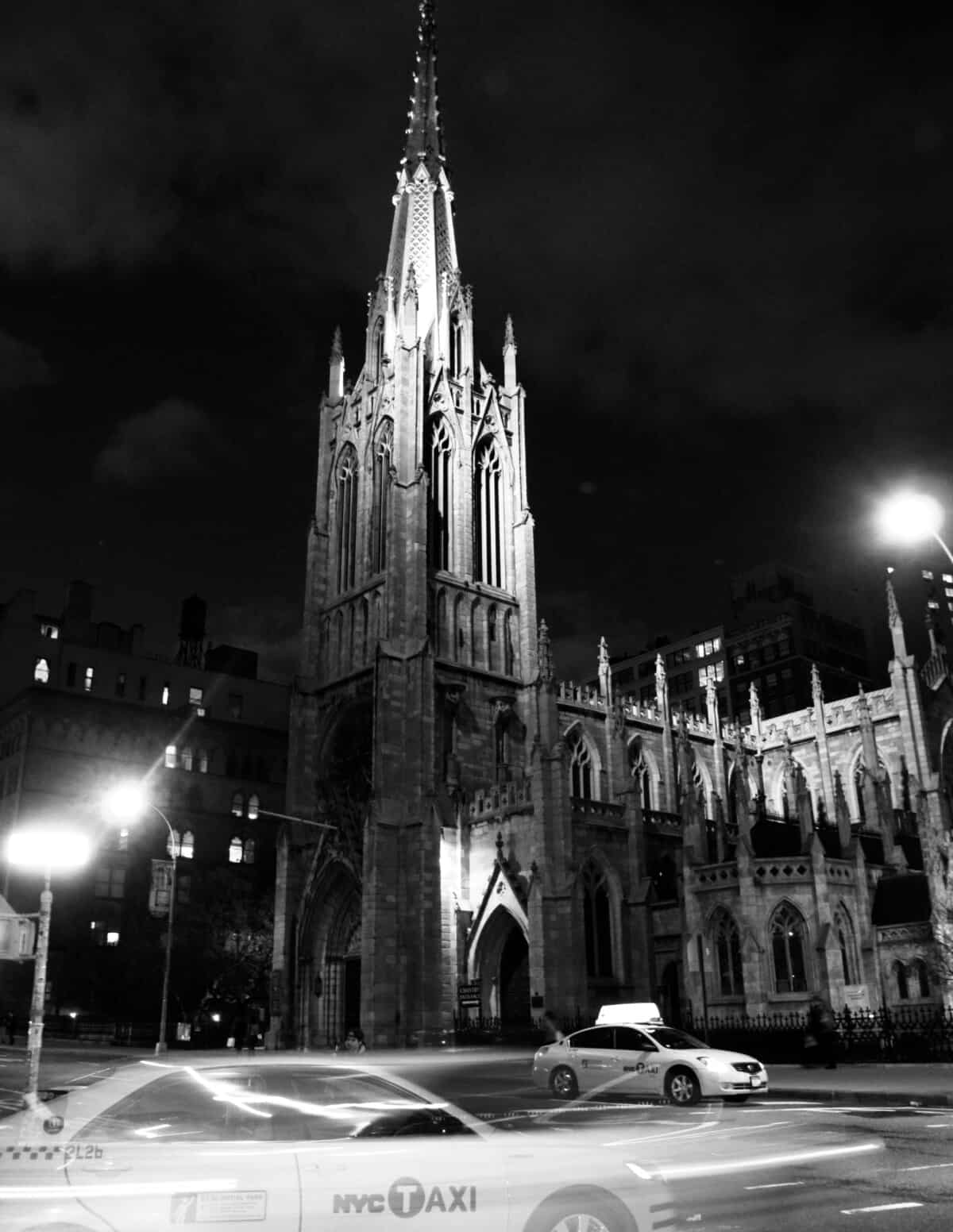 A Cathedral with Taxi's passing by,in NYC, NY.