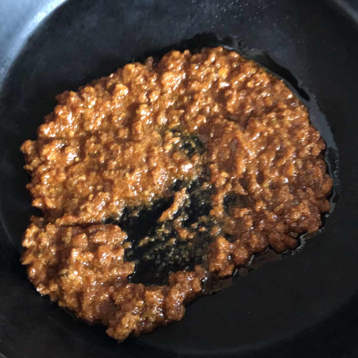 Hot bolognese sauce in a skillet ready to toss cooked spinach gnocchi into, gnocchi bolognese with an authentic bolognese ragu.
