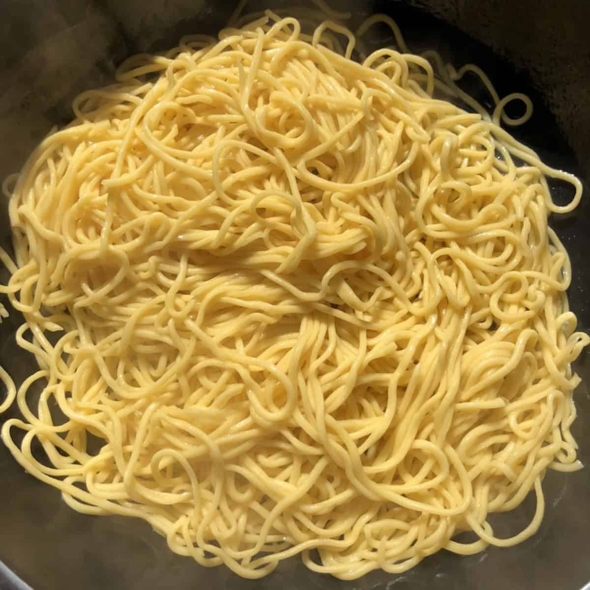 Freshly cooked homemade chitarra pasta before being added to sauce, spaghetti alla chitarra ready to toss.
