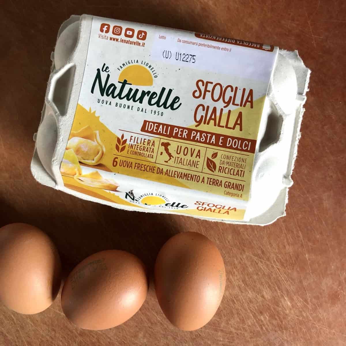 A six-count carton of Italian pasta gialla eggs with tortellini and pasta pictured on the package, eggs for making homemade egg pasta like this chitarra pasta from scratch.
