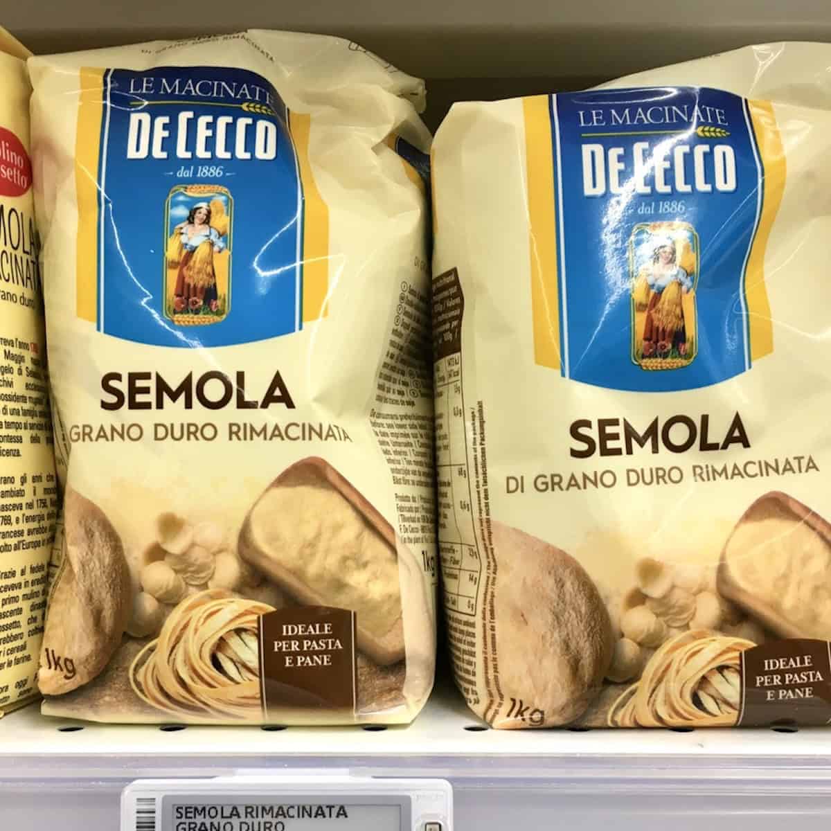 Two bags of De Cecco semolina flour semola rimacinata di grano duro on an Italian grocery store shelf, semolina flour for making spaghetti alla chitarra from scratch.
