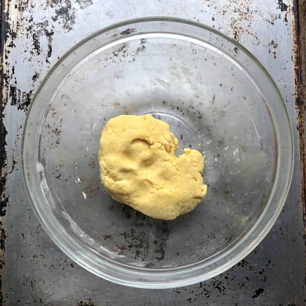 The semolina egga pasta chitarra dough just squeezed together and ready to form ball.