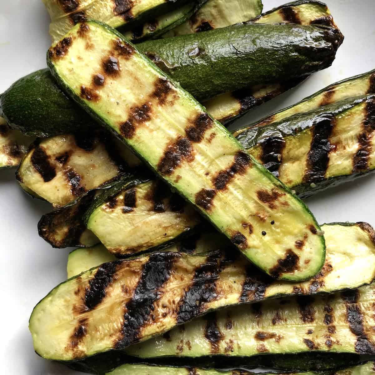 A platter with grilled zucchini on it.