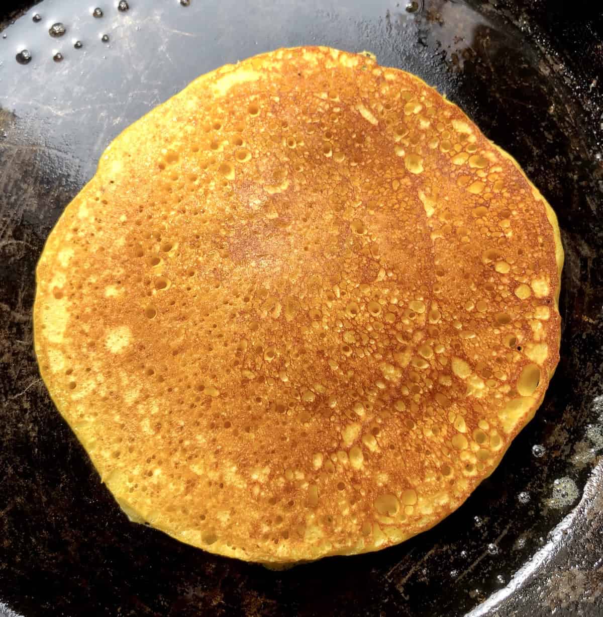 Perfectly cooked golden brown fluffy pumpkin pancakes with crispy buttery edges showing the best pumpkin pancakes recipe results for light and fluffy pumpkin pancakes from scratch.