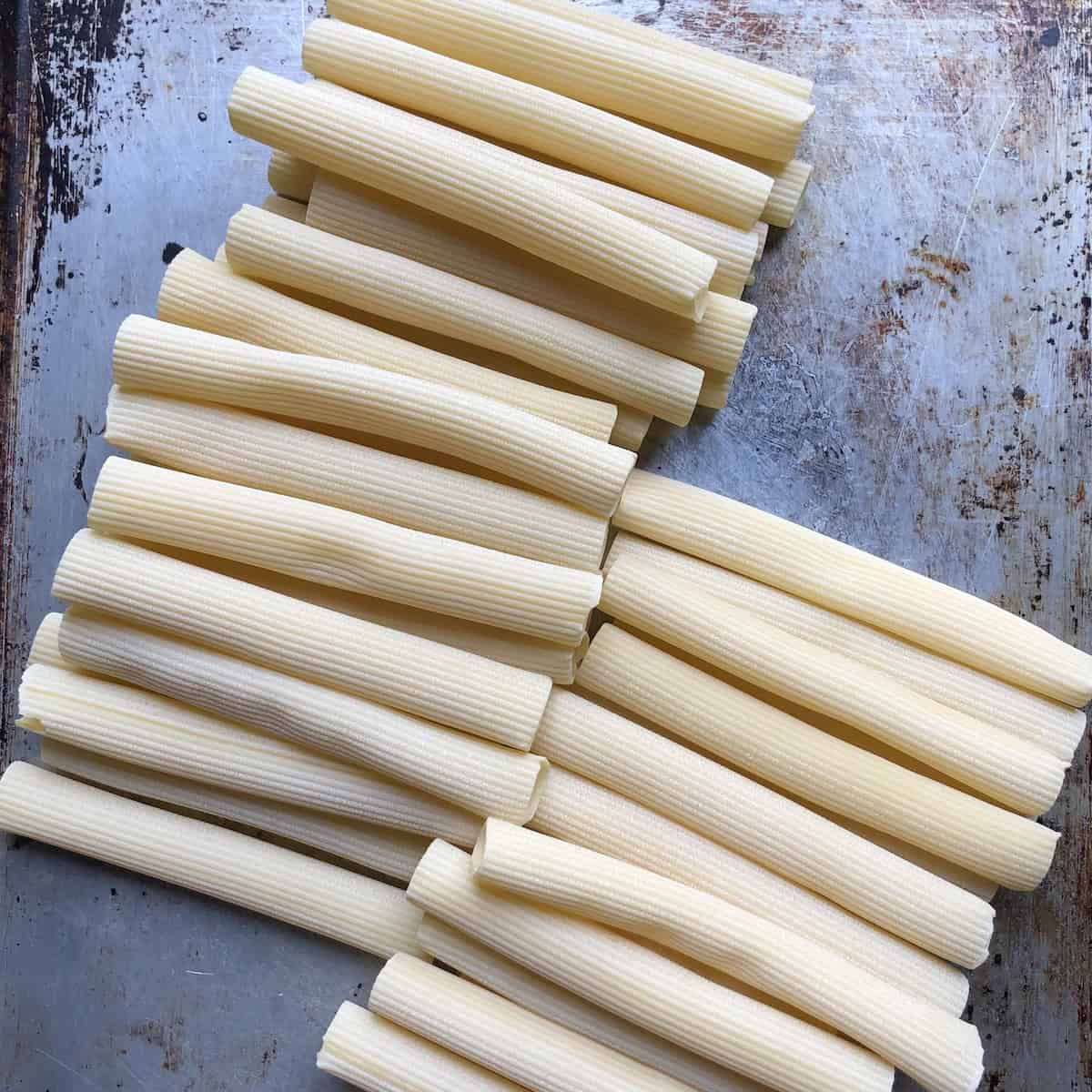 Tresactore pasta (long tube shaped semolina and water only pasta) on a sheet pan so you can see the ridges. (made by Pastaficio Maiella, Abruzzo, Italy.
