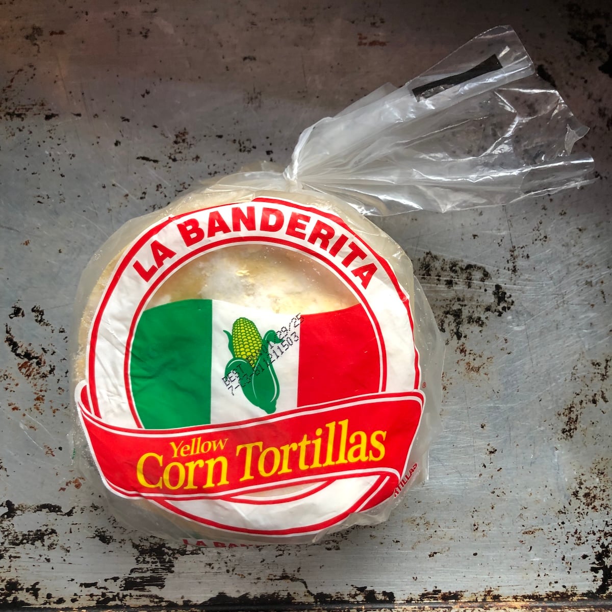 A pack of La Banderita brand yellow corn tortillas that have been frozen.
