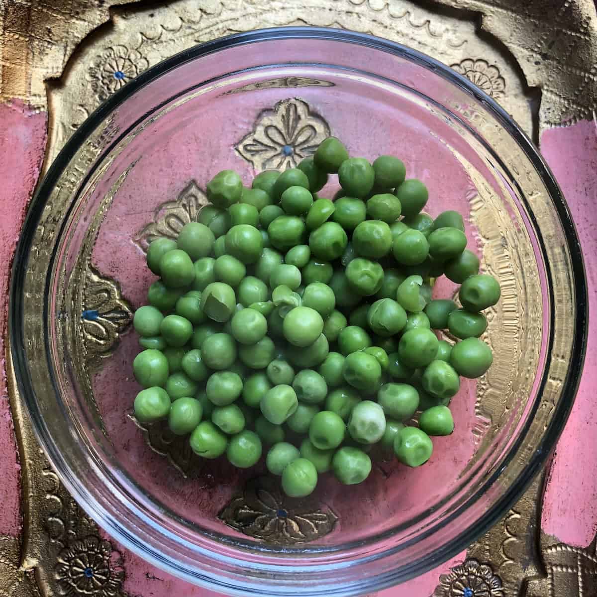 roperly soaked and drained peas for authentic Italian Mediterranean vegetable couscous recipe, showing the important preparation step of rinsing frozen peas and draining them before combining with other caramelized vegetables for homemade couscous with superior flavor.