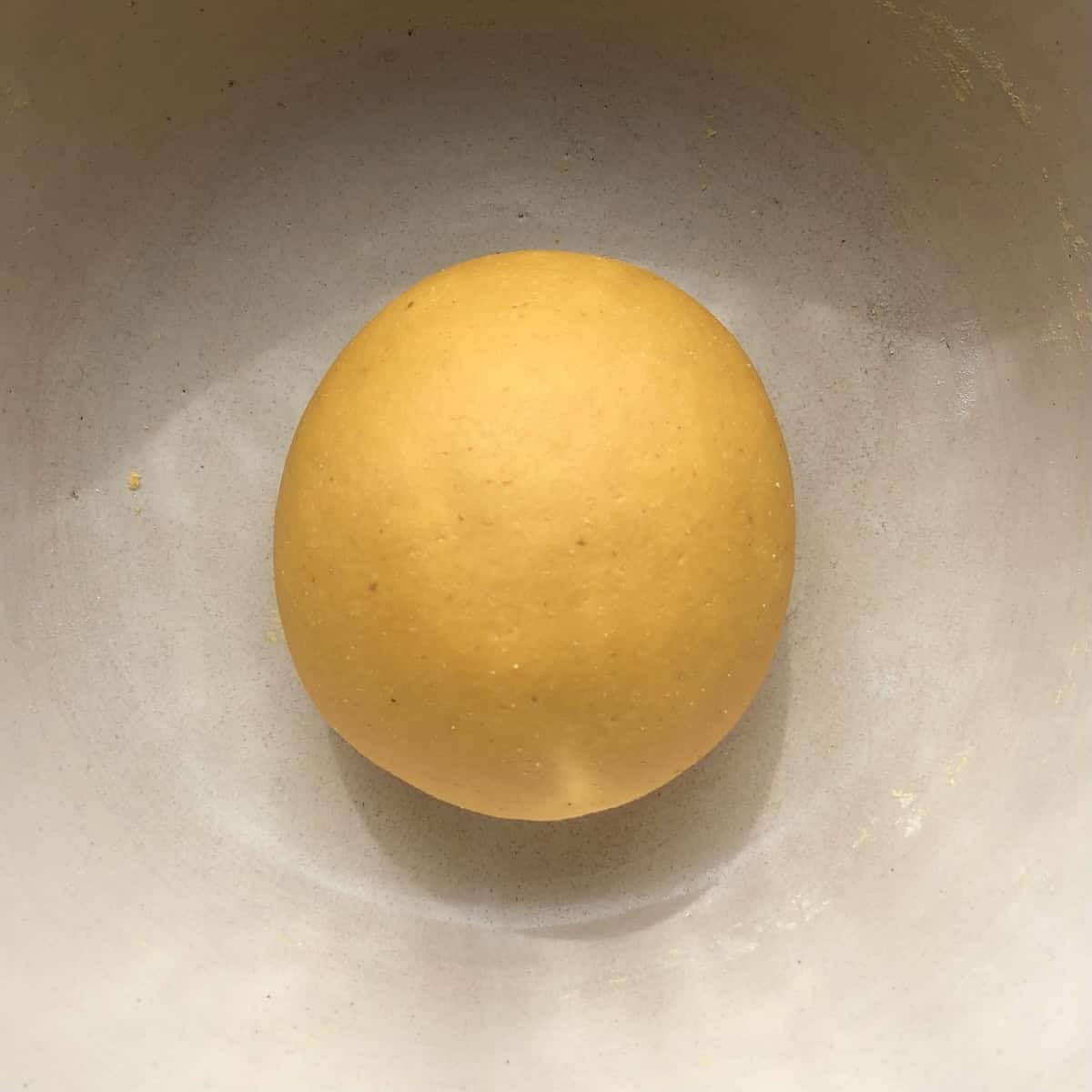 Pumpkin pasta dough kneaded smooth and ready to rest and allow the gluten to relax.