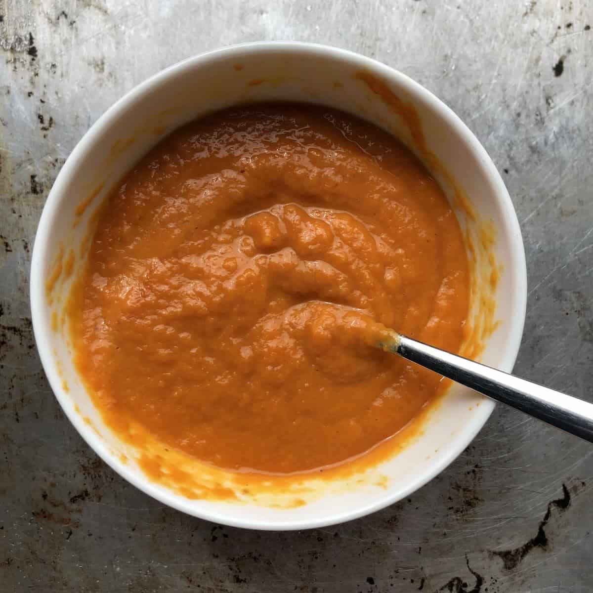 Whisked pumpkin and egg mixture for homemade pumpkin pasta.
