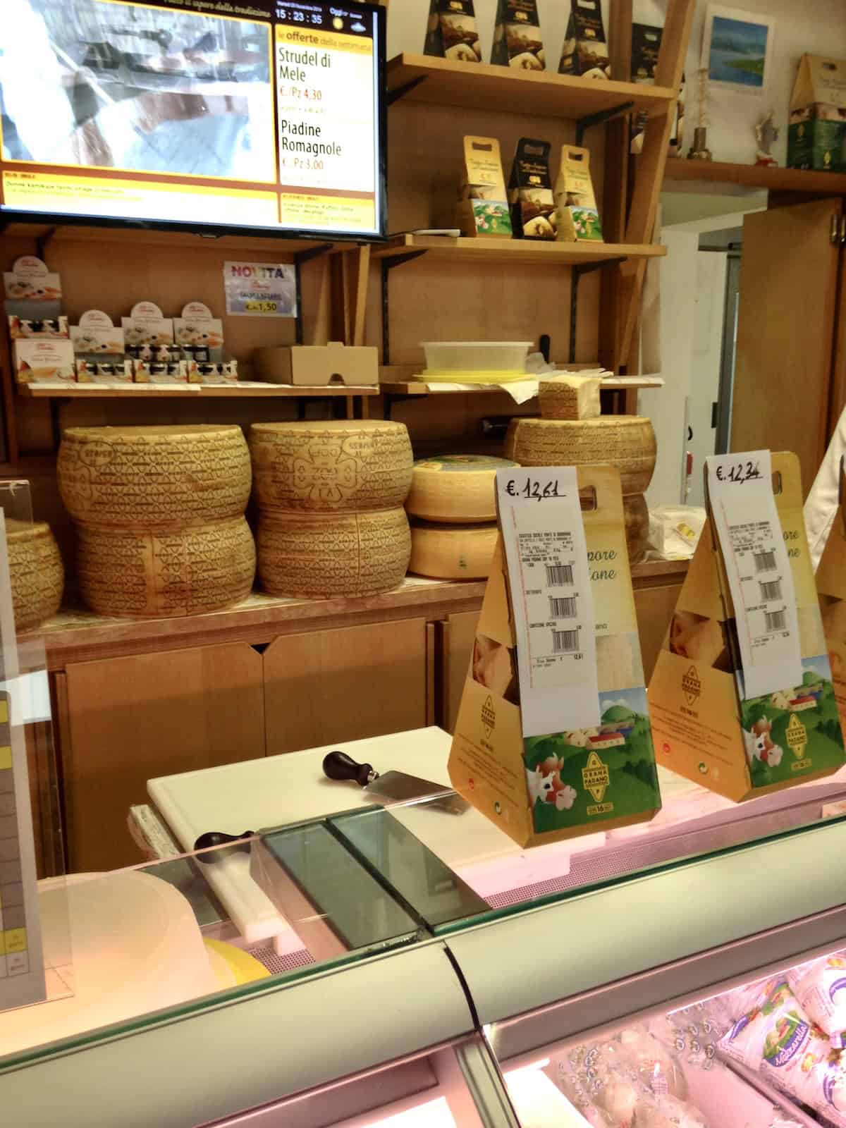 Aged grana padano cheese wheels stacked at my local Italian caseficio in Barbarano Italy where I source my cheese rinds for homemade chicken broth secret ingredient and our cheese to bring home.
