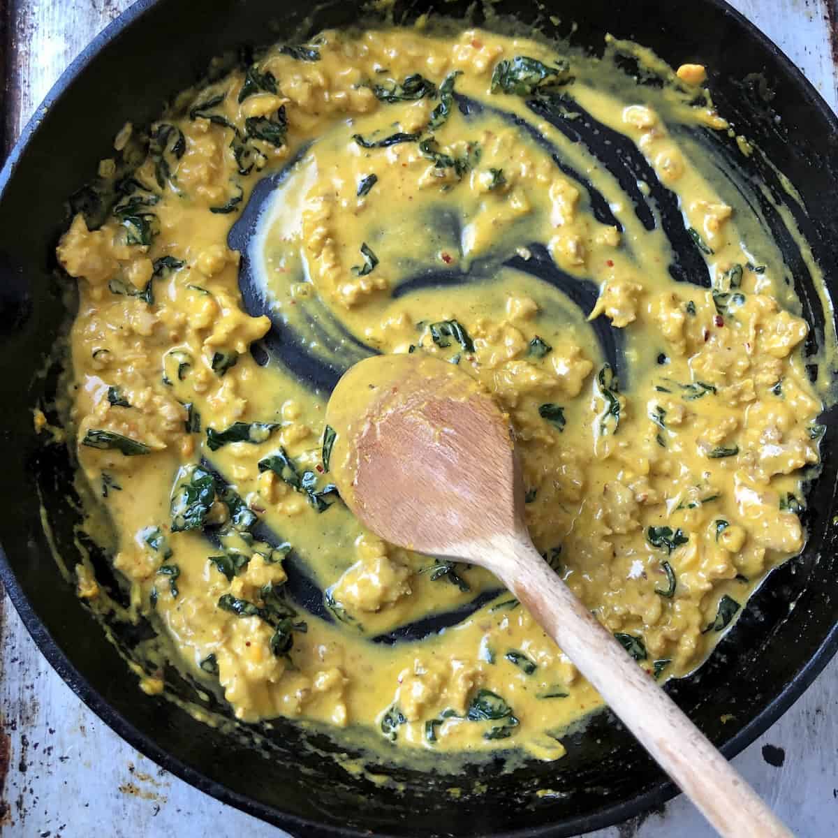 Creamy pumpkin pasta sauce finished with pasta water showing silky pumpkin cream sauce at perfect consistency before adding pasta.
